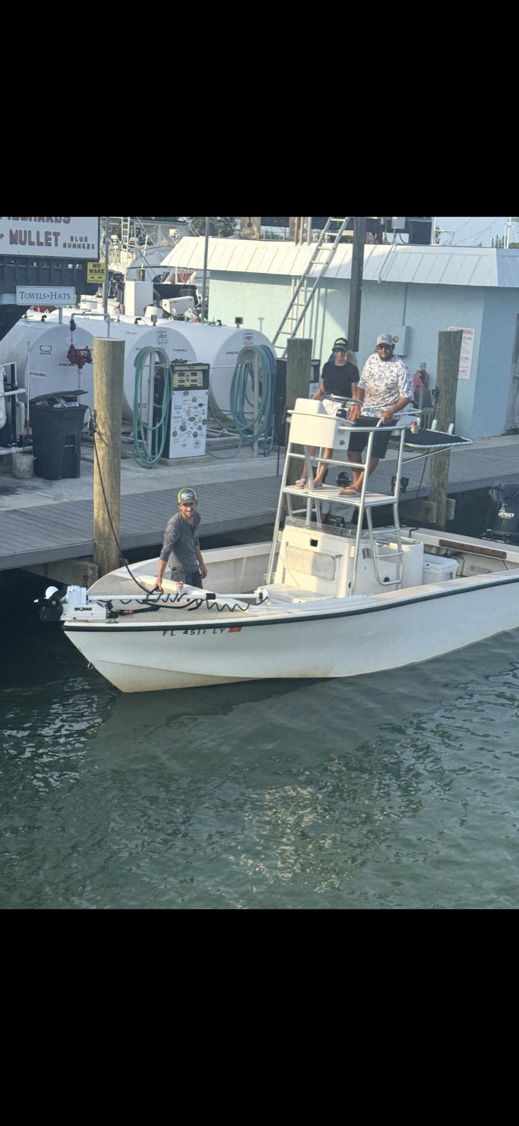 24-foot T-Craft center console with T-top and tower at the Marathon dock