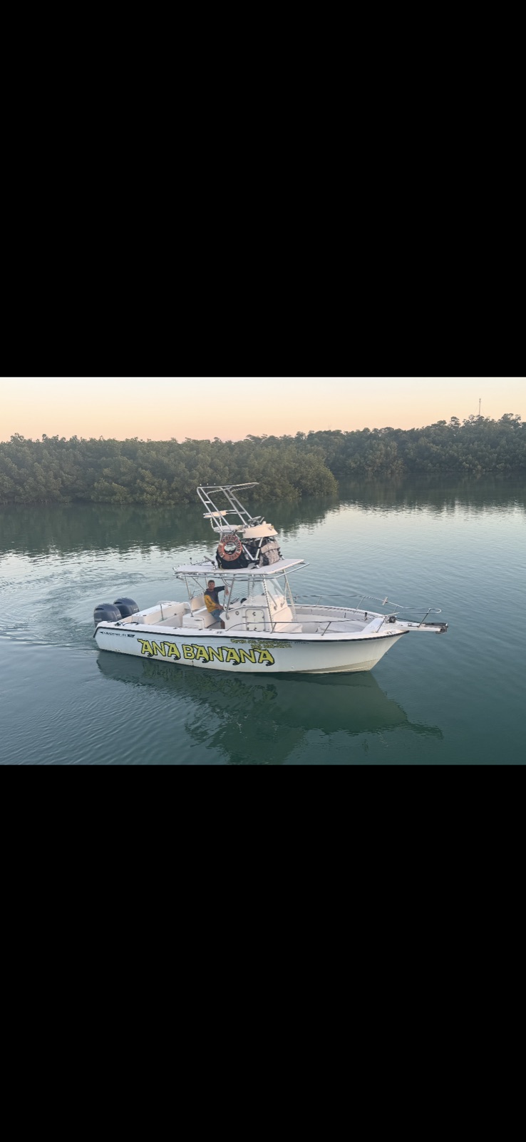 30-foot Grady White center console with twin tower platform and yellow Ana Banana lettering at dusk