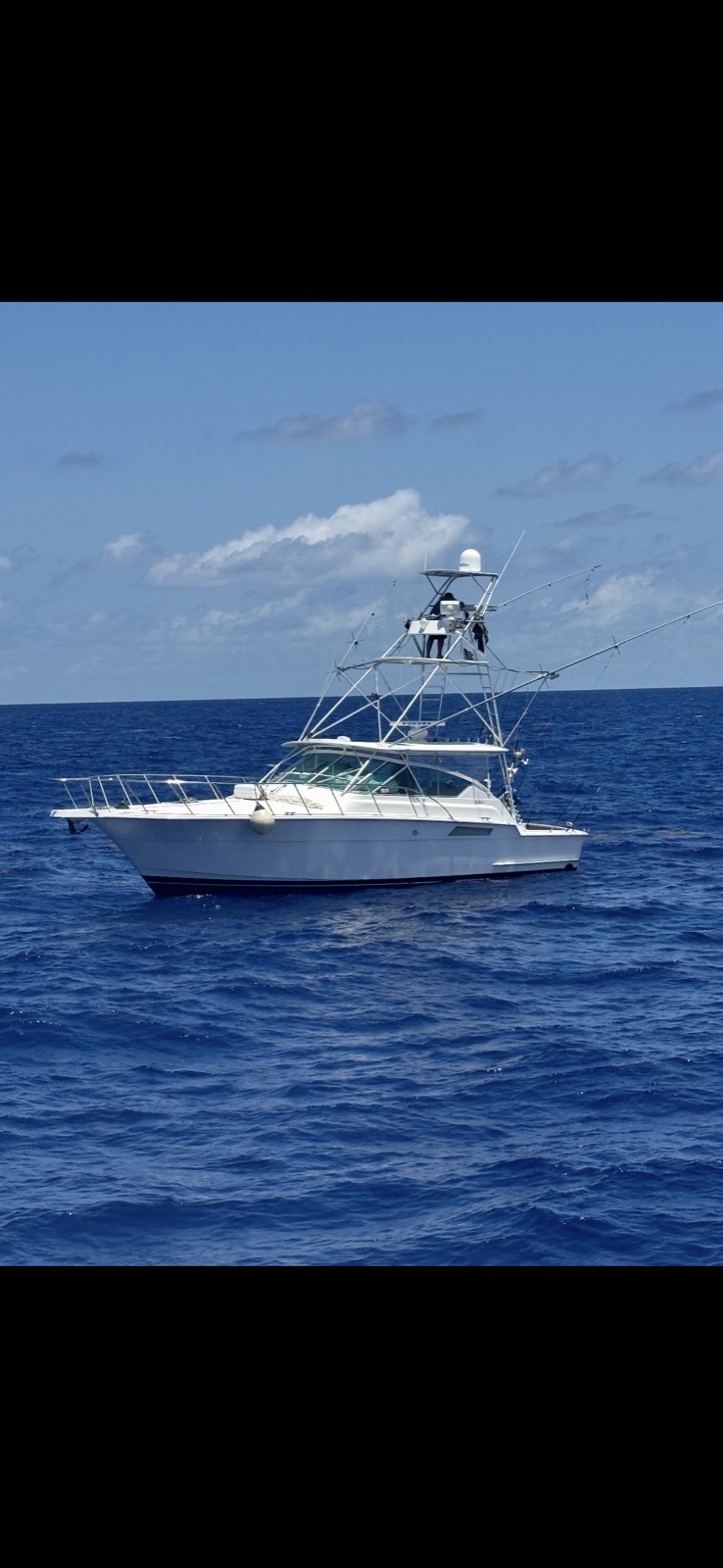 45-foot Hatteras Express sportfish with white hull at rest in deep blue offshore water