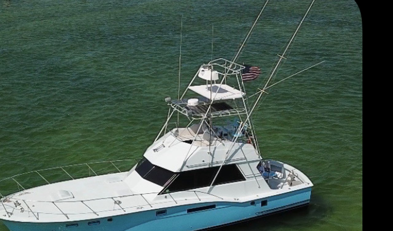 46-foot Hatteras Convertable sportfish with white hull and teal bottom paint