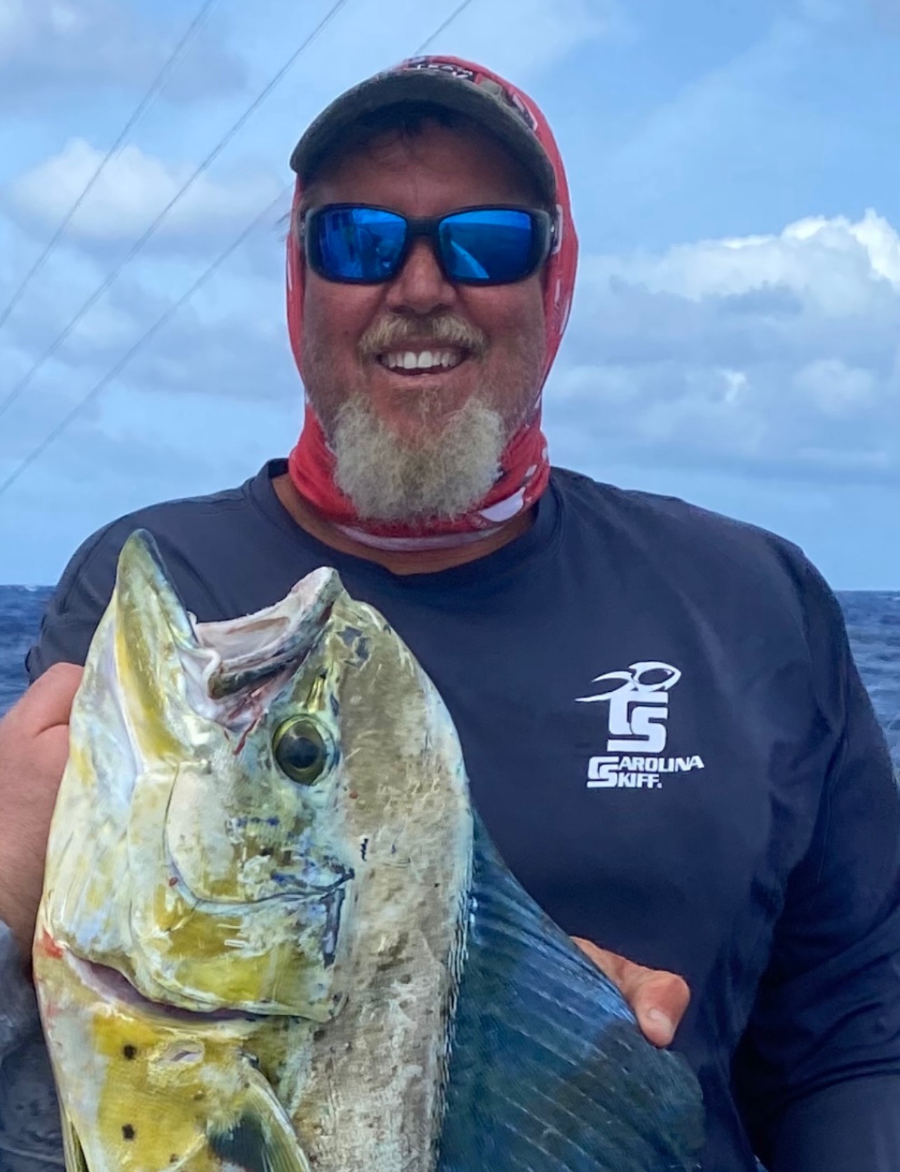 Captain Joel holding a mahi-mahi caught offshore deep sea fishing in the Florida Keys